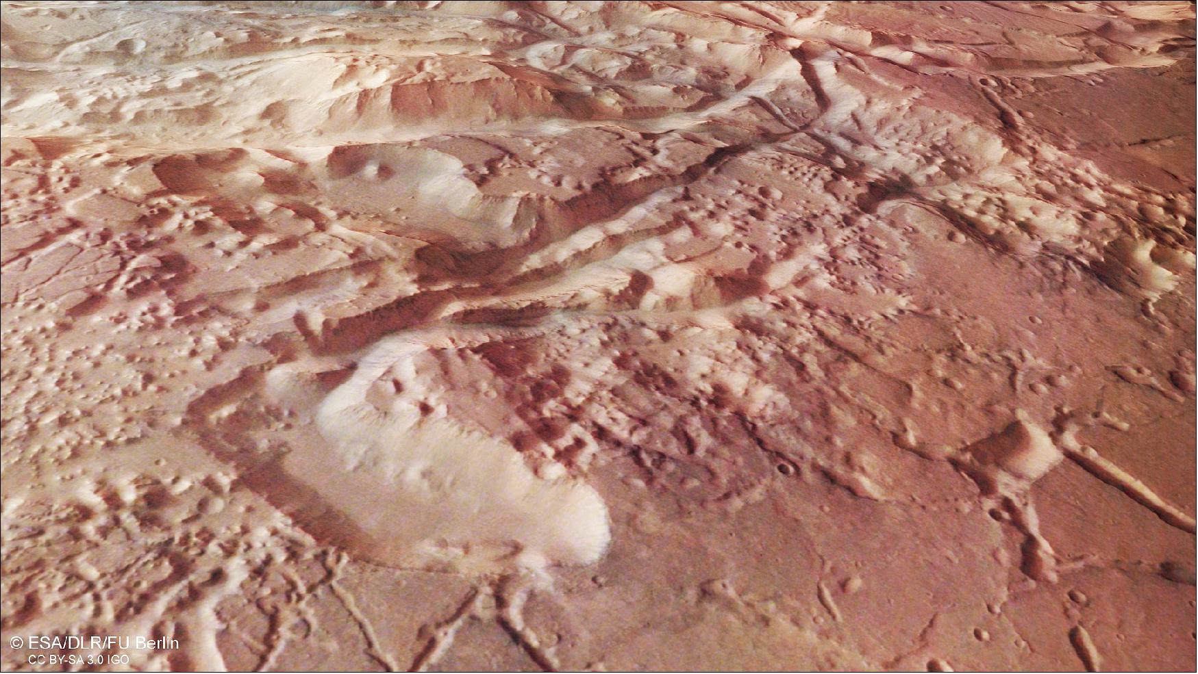 Figure 32: Perspective view of Aurorae Chaos. This image from ESA's Mars Express shows Aurorae Chaos, a large area of chaotic terrain located in the Margaritifer Terra region on Mars. This oblique perspective view was generated using a digital terrain model and Mars Express data gathered on 31 October 2018 during orbit 18765. The ground resolution is approximately 14 m/pixel and the images are centered at about 327ºE/11ºS. This image was created using data from the nadir and color channels of the High Resolution Stereo Camera. The nadir channel is aligned perpendicular to the surface of Mars, as if looking straight down at the surface (image credit: ESA/DLR/FU Berlin, CC BY-SA 3.0 IGO)