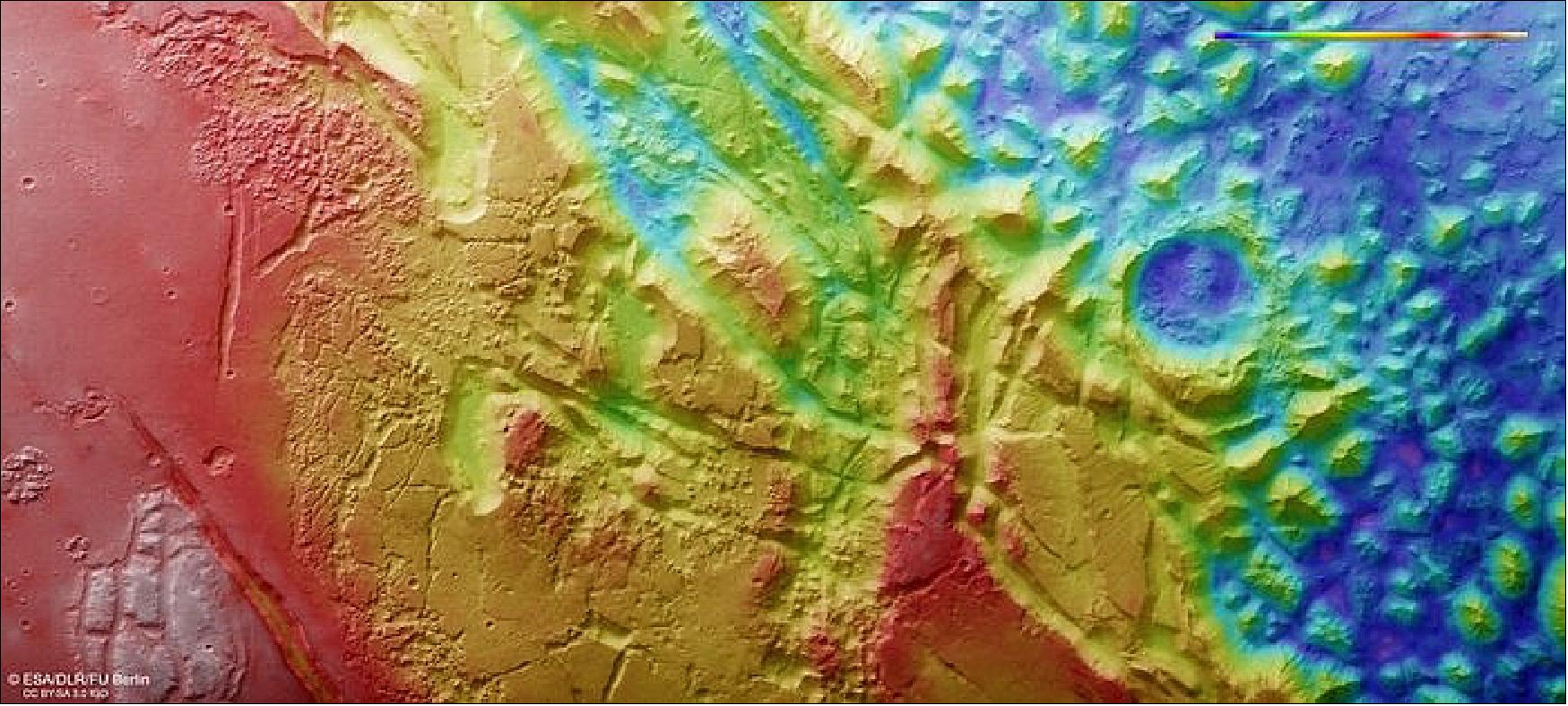 Figure 31: This color-coded topographic view shows Aurorae Chaos, a large area of chaotic terrain located in the Margaritifer Terra region on Mars. Lower parts of the surface are shown in blues and purples, while higher altitude regions show up in whites, yellows, and reds, as indicated on the scale to the top right. This view is based on a digital terrain model of the region, from which the topography of the landscape can be derived. It comprises data obtained by the High Resolution Stereo Camera on Mars Express on 31 October 2018 during orbit 18765. The ground resolution is approximately 14 m/pixel and the images are centered at about 327ºE/11ºS. North is to the right (image credit: ESA/DLR/FU Berlin, CC BY-SA 3.0 IGO)