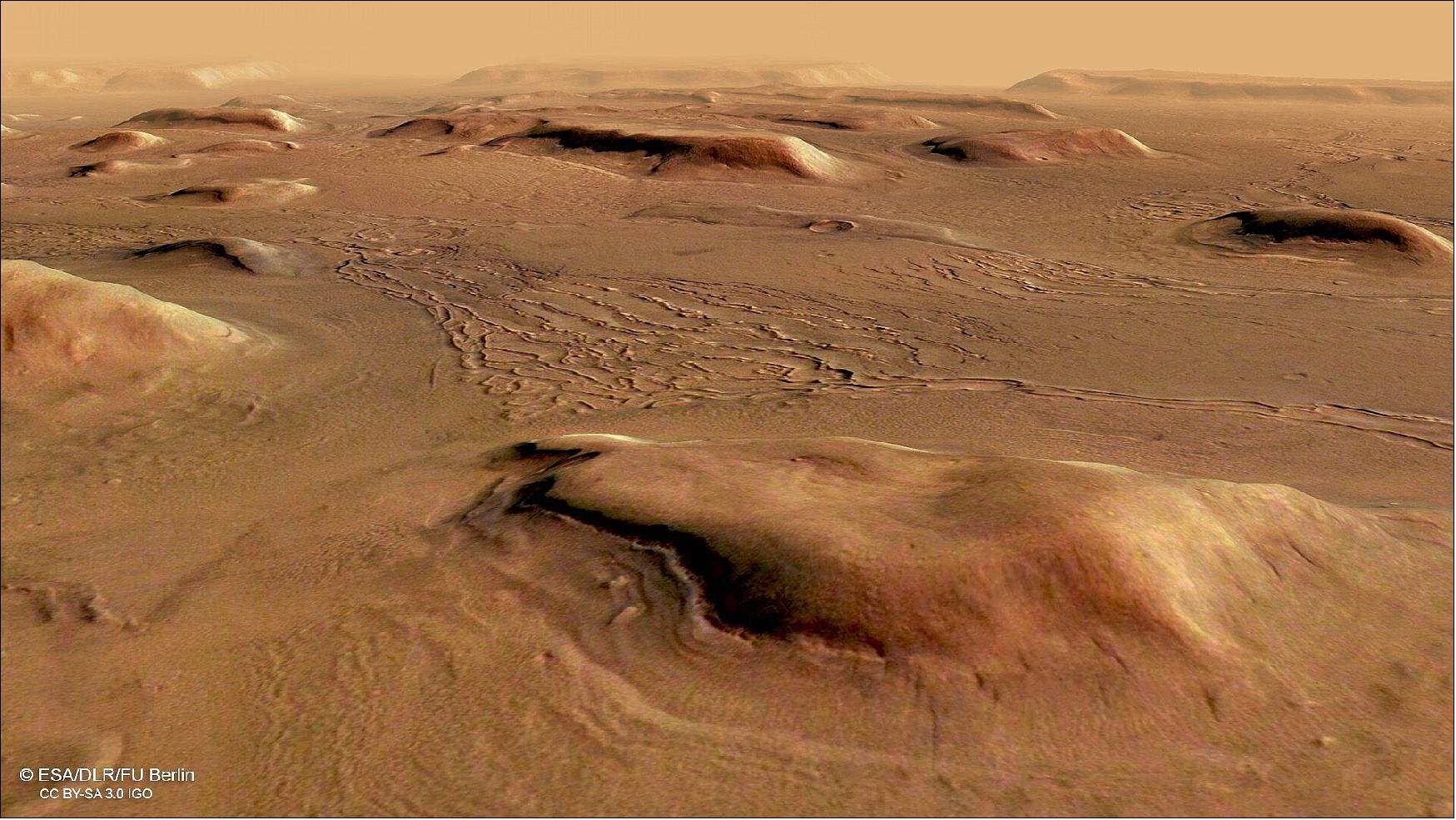 Figure 6: Perspective view of Deuteronilus Mensae. This image from ESA's Mars Express shows a region of Mars named Deuteronilus Mensae. This oblique perspective view was generated using a digital terrain model and Mars Express data gathered on 25 February 2018 during orbit 17913. The ground resolution is approximately 13 m/pixel and the images are centered at about 25.5ºE/44ºN. This image was created using data from the nadir and color channels of the High Resolution Stereo Camera (HRSC). The nadir channel is aligned perpendicular to the surface of Mars, as if looking straight down at the surface.