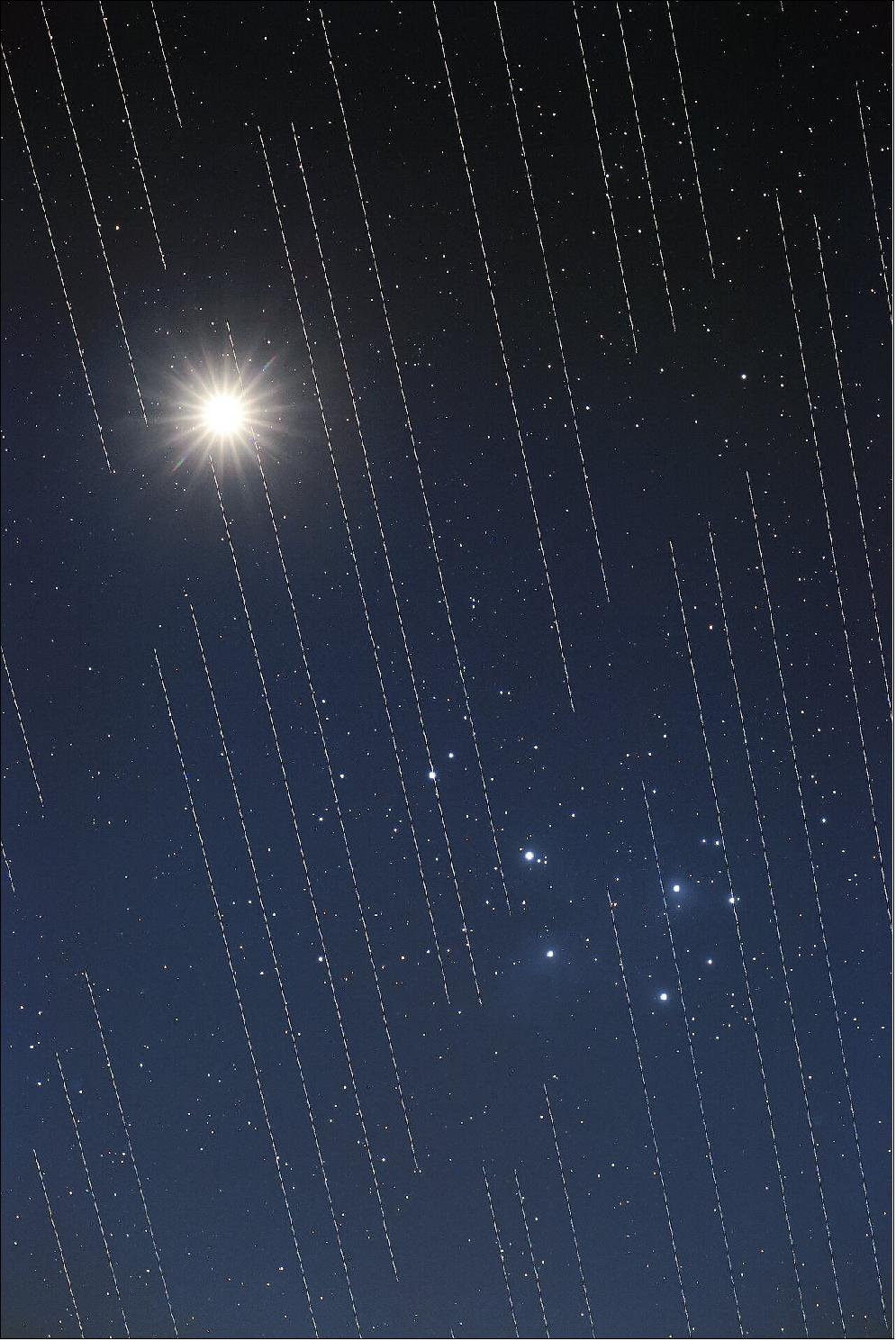 Figure 3: This image of Venus and the Pleiades shows the tracks of Starlink satellites. The reflective surfaces of the satellites, coupled with the fact that they are orbiting around Earth, mean that astronomical observations that require very long exposures capture "tracks" of the satellites in their images. - his image by Torsten Hansen of Germany won third place in the 2021 IAU OAE Astrophotography Contest, category Light Pollution (image credit: T. Hansen/IAU OAE/Creative Commons Attribution)