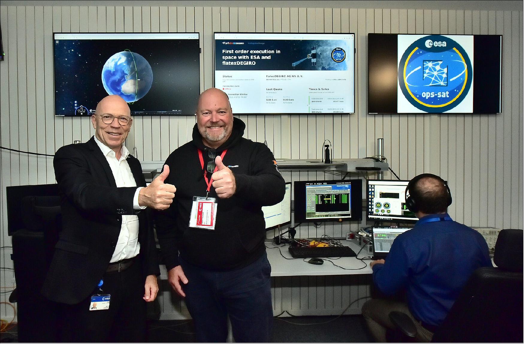 Figure 25: The first stock trade in space took place onboard ESA's OPS-SAT Space Lab on 30 September 2021. In the SMILE control room at ESA's ESOC mission control, Director of Operations Rolf Densing and CEO of flatexDEGIRO, Frank Niehage, witnessed the transaction (image credit: Martin Joppen)