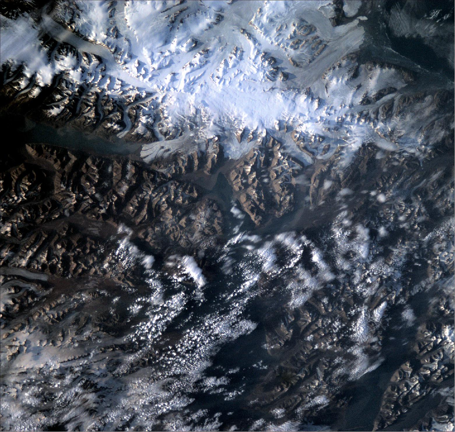 Figure 14: Space laboratory sees snowy Svalbard. This rugged, remote terrain is one of the world's northernmost inhabited regions. A Norwegian archipelago in the Arctic Ocean, part way between Norway and the North Pole, Svalbard is made up of glaciers and frozen tundra. This photo was captured by OPS-SAT, ESA’s space laboratory, as it underwent commissioning of its high-definition camera on 26 July 2020. At an altitude of more than 500 km, the small spacecraft managed to capture the beautiful detail of this unique region, including the long, horizontal body of water at the top-left of the image, the notorious 32 km long Austfjorden fjord of Svalbard (image credit: ESA)