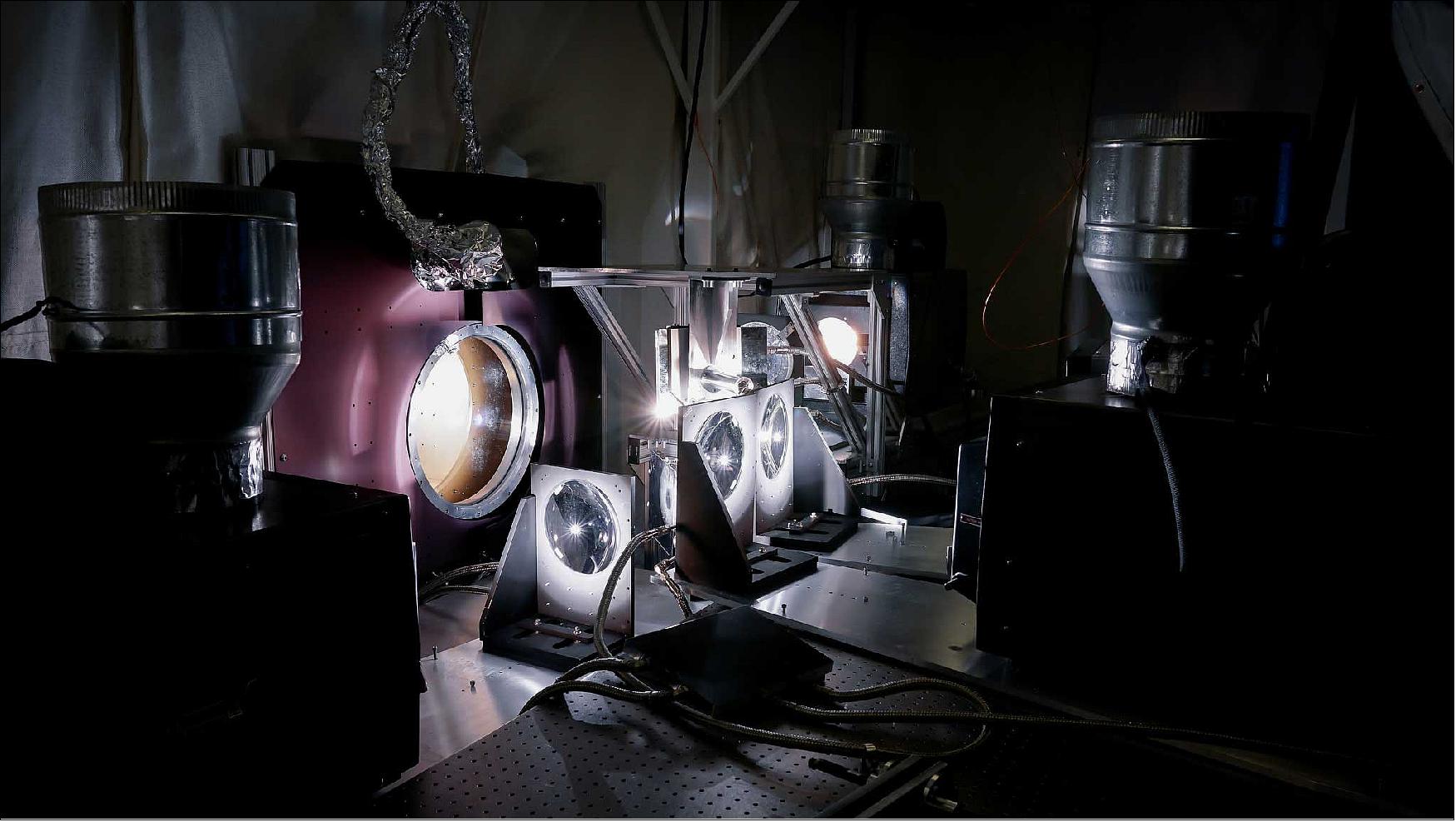Figure 124: Researchers use a quartet of IMAX projectors to create the light and heat the Parker Solar Probe cup will experience during its trips through the sun's atmosphere. The cup sits inside a vacuum chambers set up in a lab at the Smithsonian Astrophysical Observatory in Cambridge, Massachusetts (image credit: Levi Hutmacher, Michigan Engineering)