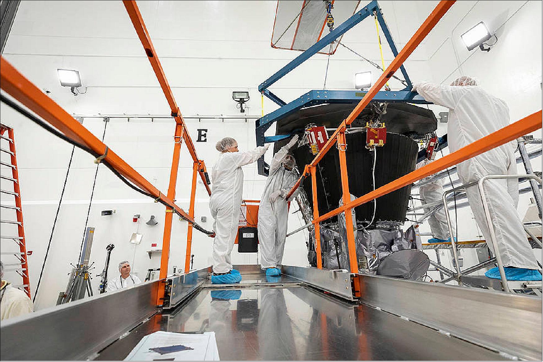 Figure 122: Parker Solar Probe’s heat shield, the TPS, is lifted and realigned with the spacecraft’s truss as engineers from the Johns Hopkins Applied Physics Lab prepare to install the eight-foot-diameter heat shield on June 27, 2018 (image credit: NASA/Johns Hopkins APL/Ed Whitman)