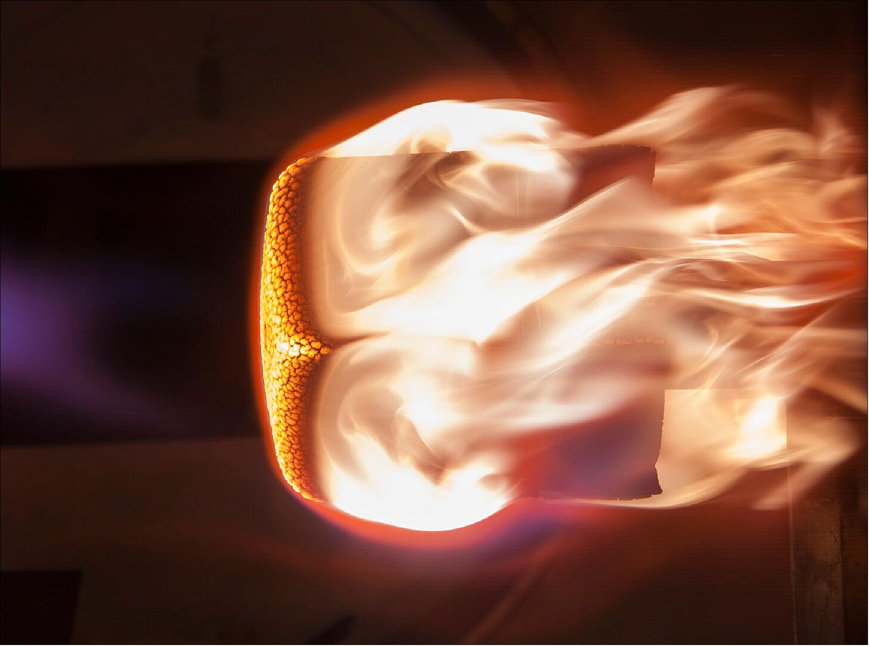 Figure 4: The cork heat shield of ESA's Qarman CubeSat burning away in simulated atmospheric reentry conditions, during ground testing (image credit: VKI)