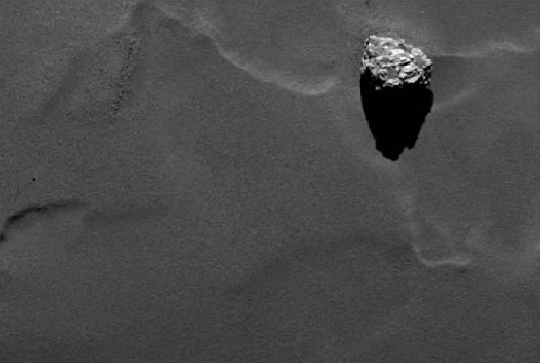 Figure 166: Close-up of the boulder Cheops as it casts a long shadow on the surface of comet 67P/Churyumov-Gerasimenko, (image credit: ESA, Rosetta,MPS for OSIRIS Team MPS, UPD, LAM, IAA, SSO, INTA, UPM, DASP, IDA)