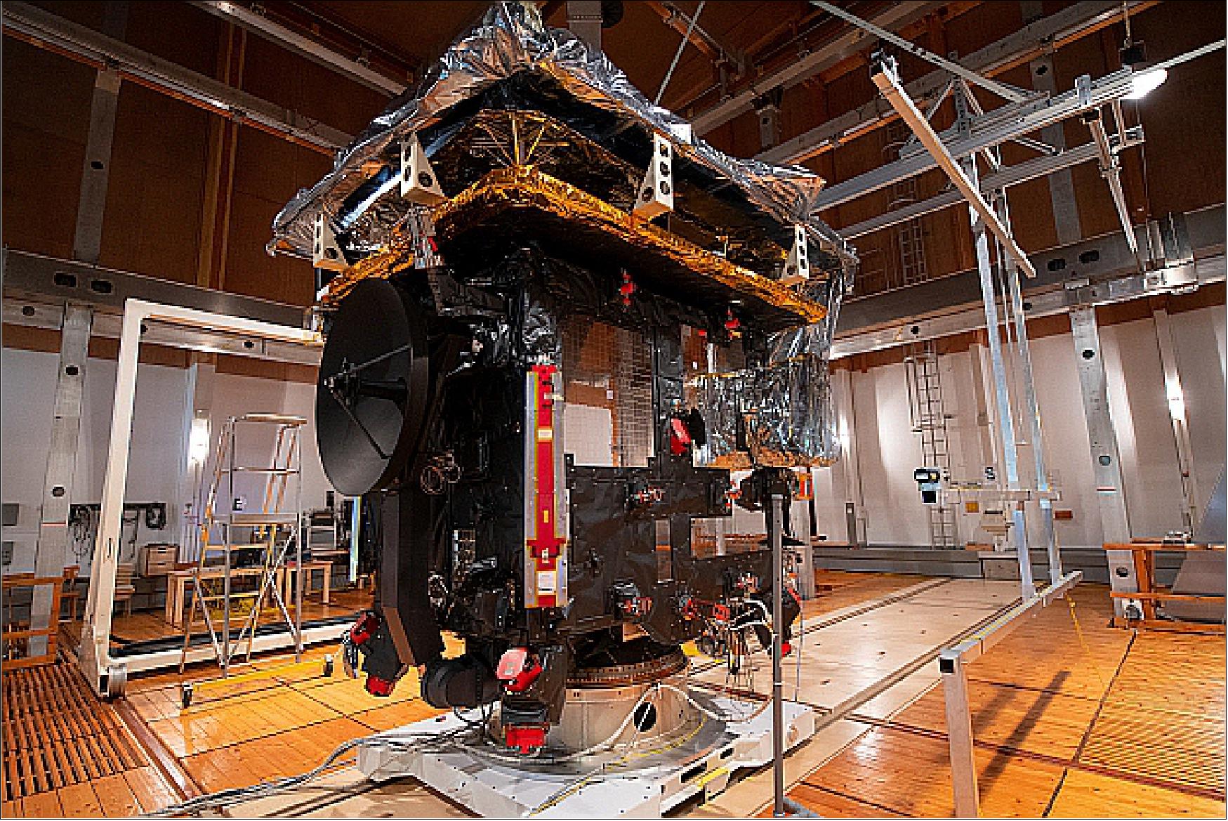 Figure 9: The Solar Orbiter spacecraft in the IABG magnetic field simulation facility in Ottobrunn, Germany. The facility is located just outside the premises in a nearby forest to avoid interference with human-generated magnetic fields, consists completely of non-magnetic materials like wood, and contains twelve 15 m coils – nearly as large as the building – to create a homogeneous magnetic environment that compensates Earth's own magnetic field, simulating outer space conditions. Tests performed here in June 2019 verified the magnetic behavior of the unpowered spacecraft, to make sure the magnetic field of Solar Orbiter is low enough so that the Magnetometer (MAG) instrument can operate at its most sensitive range (image credit: ESA–S. Corvaja)