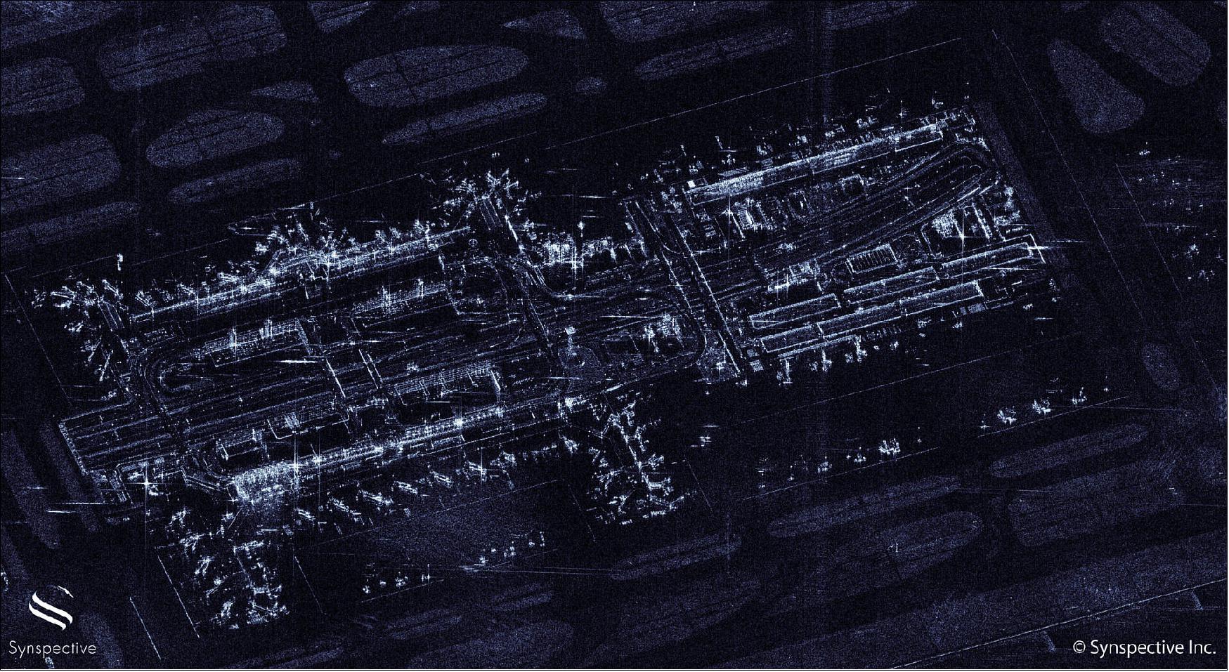 Figure 11: The airport has three terminals, of which two terminals are seen in this image. You can also see the control tower, at the center of the image. The planes are lined up and parked at aprons, ready for departure. Taxiways to lead the planes to runways are also clearly observed (image credit: Synspective)