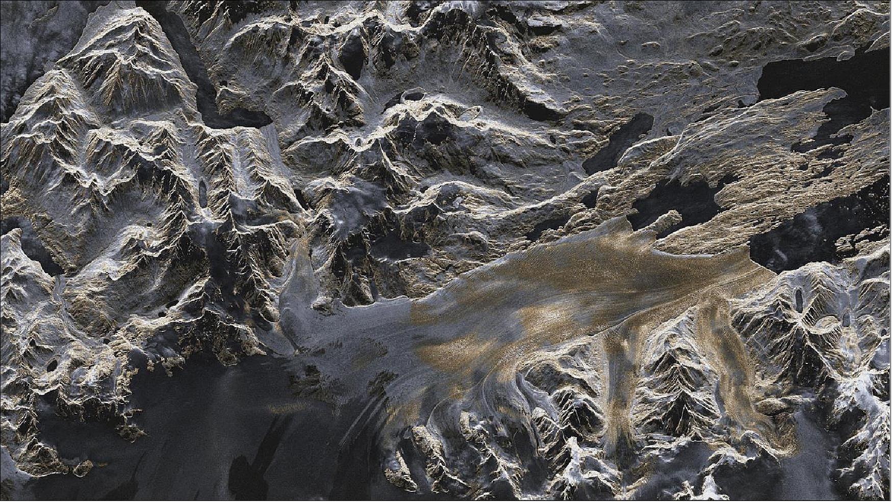Figure 26: TerraSAR-X image of the Upsala Glacier in Patagonia, Argentina. Artificially colored TerraSAR-X image (strip mode) of the Upsala Glacier, created using data acquired on 7 January 2008. The colors provide information about the roughness of the terrain. Areas that appear predominantly smooth to the radar are tinted in darker shades of blue and gray. Areas with a coarser surface texture are shown in yellow [image credit: DLR (CC-BY 3.0)]