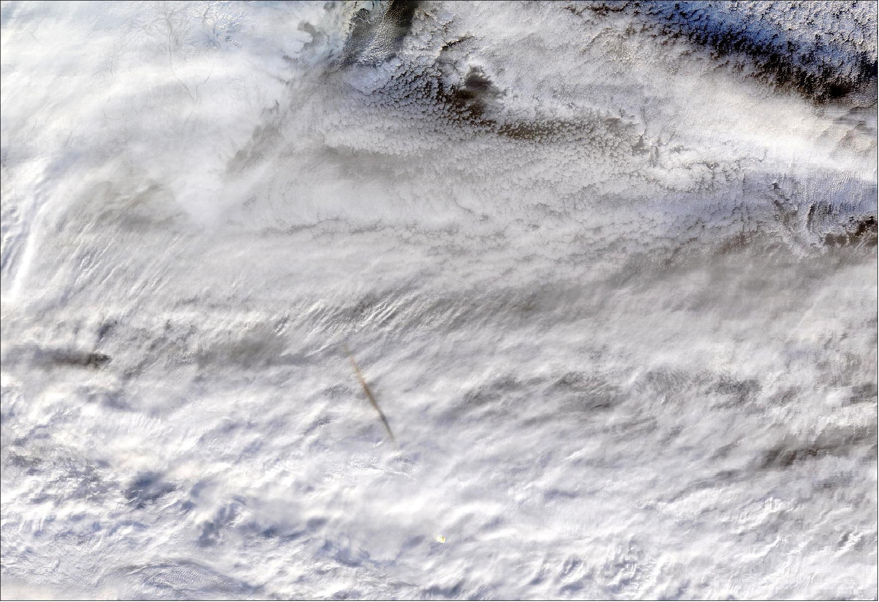 Figure 44: The MODIS instrument captured this true-color image showing the remnants of a meteor's passage, seen as a dark shadow cast on thick, white clouds on Dec. 18, 2018. MODIS captured the image at 23:50 UTC (image credit: NASA/GSFC)