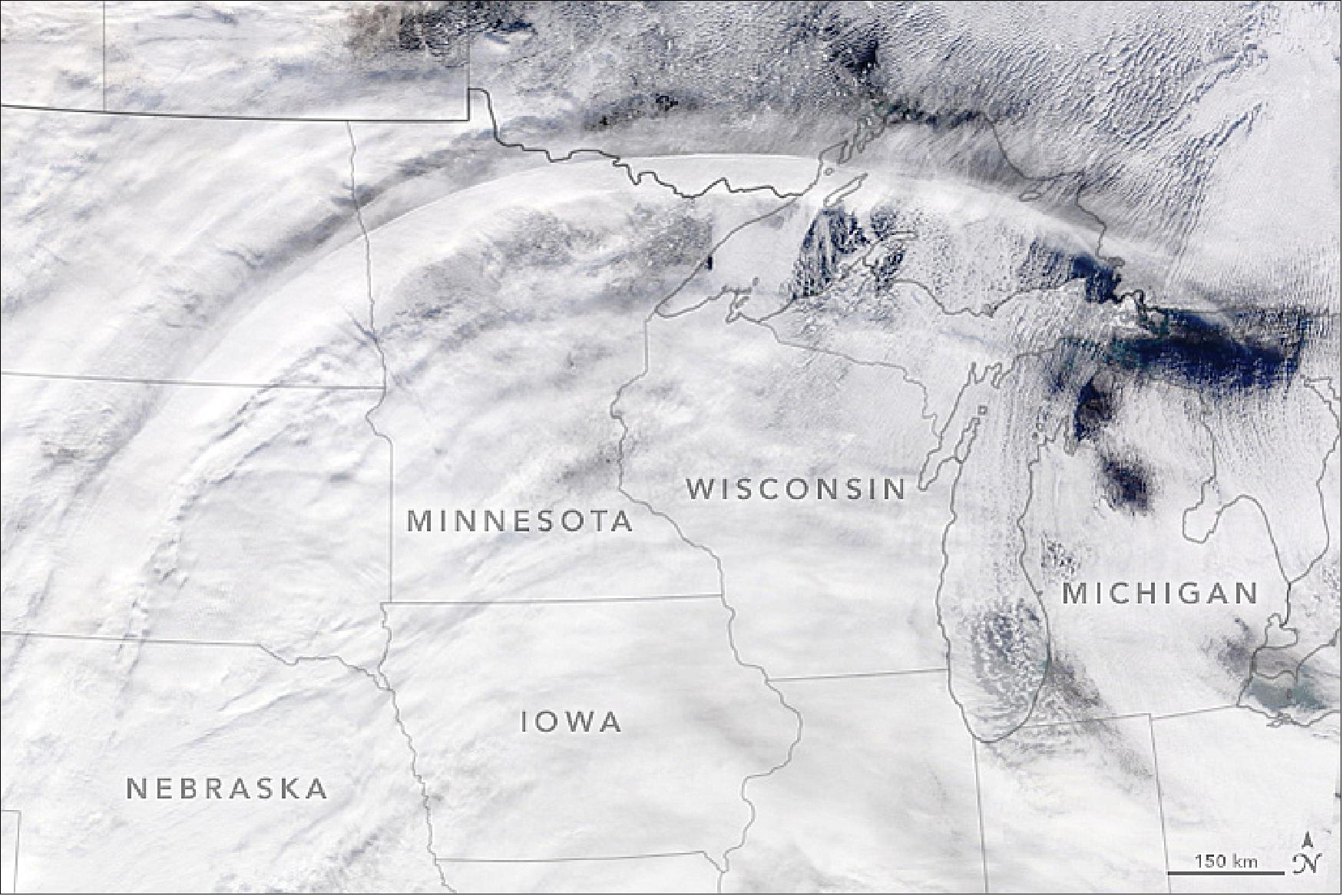Figure 8: Circulation around a jet streak—a fast-moving pocket of air within the jet stream—formed this distinctive arc of clouds. The presence of a jet streak is not often apparent in natural-color satellite imagery, but occasionally there are tell-tale signs. That was the case on November 28, 2019, when the MODIS instrument on NASA’s Terra satellite captured this image of a wide arc of clouds stretching across the northern United States. At the time, a powerful winter storm was building in the East (image credit: NASA Earth Observatory, image by Lauren Dauphin, using MODIS data from NASA EOSDIS/LANCE and GIBS/Worldview. Story by Adam Voiland)