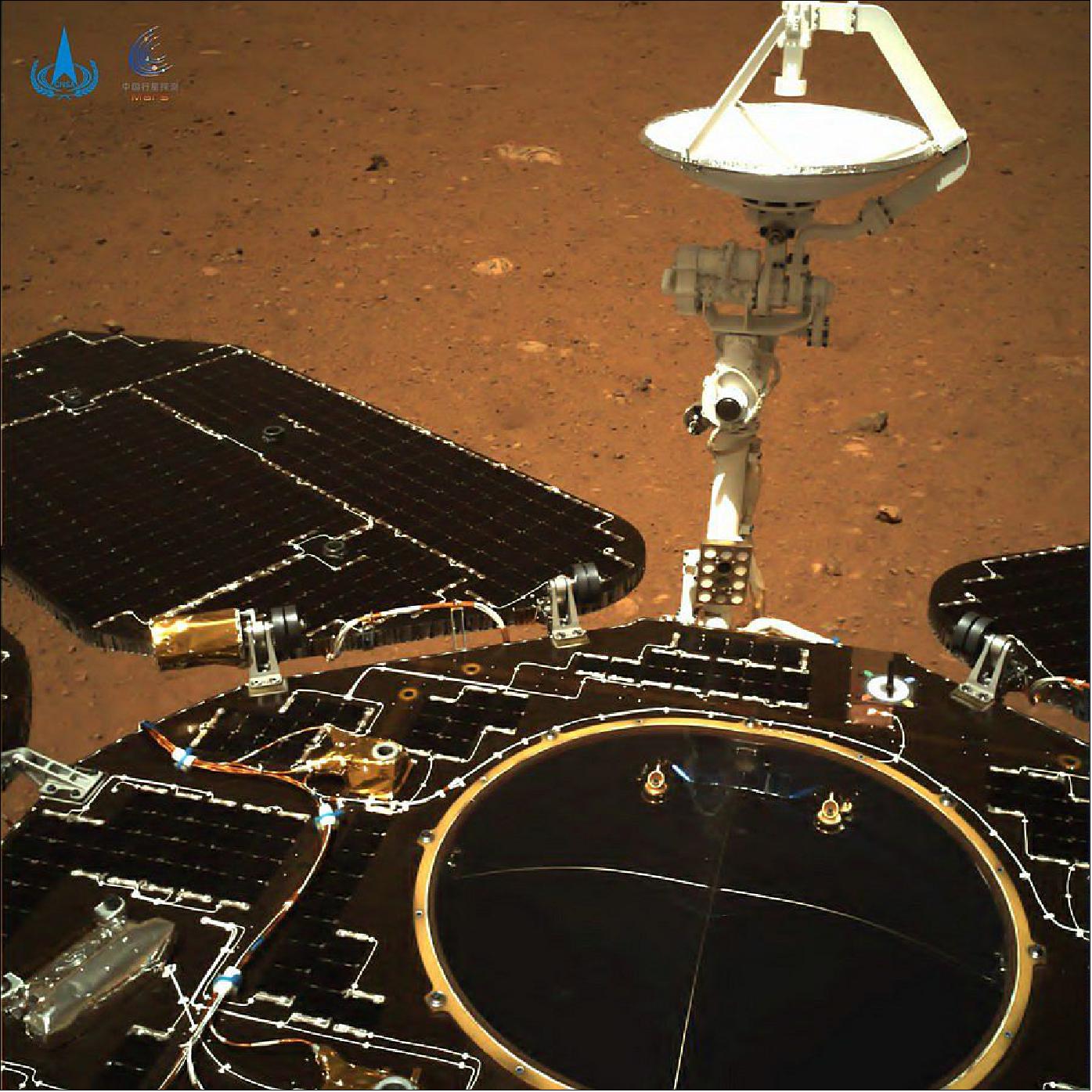 Figure 21: In the color photo taken by the navigation camera of Tianwen-1 probe towards the rear of the rover, the rover's solar panels and antenna are seen unfolded, and the red soil and rocks on the Martian surface are clearly visible (image credit: CNSA)