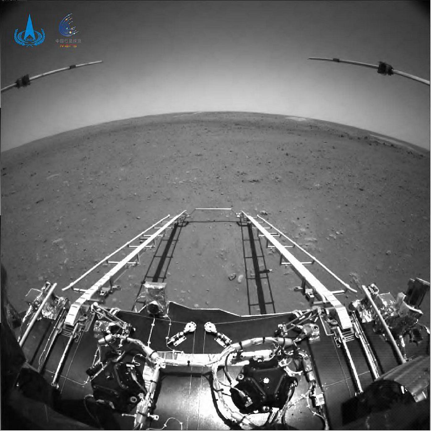 Figure 20: The black and white image taken by an obstacle avoidance camera installed in front of the rover of China's Mars probe Tianwen-1 shows that a ramp on the lander has been extended to the surface of Mars. The terrain of the rover's forward direction is clearly visible in the image, and the horizon of Mars appears curved due to the wide-angle lens (image credit: CNSA)